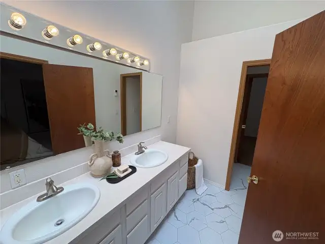 This second view of the double vanity reveals the private toilet nook beyond—and a convenient connection to the second bedroom, perfect for guests or flexible living.