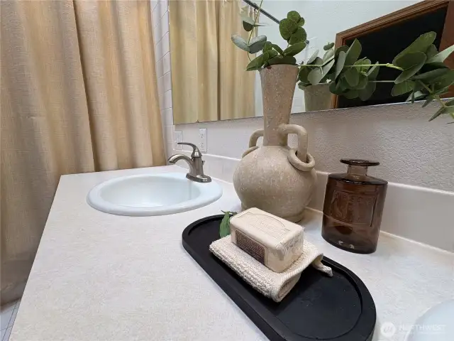 Sleek brushed silver faucets and a polished countertop add a touch of modern elegance to the double vanity—blending style with everyday function.
