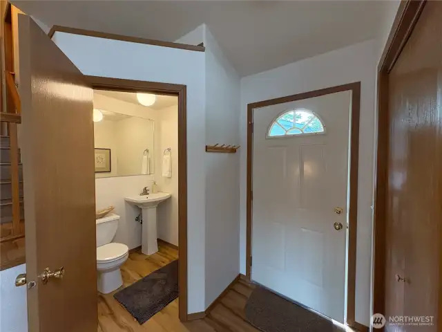 Conveniently located off the entry, the main-level half bath features a toilet and pedestal sink—perfect for guests and everyday use