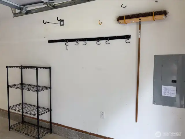 Two sturdy shelving units, and a broom organizer, all of which convey with the home.