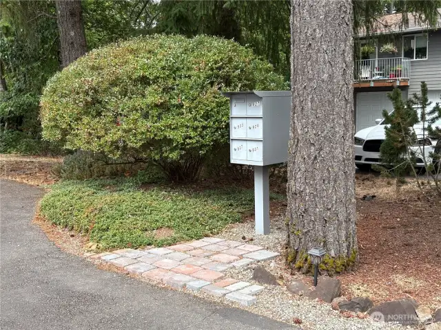 Even the mailbox hints at the natural beauty surrounding this home—nestled in a wooded setting that offers a peaceful, Northwest feel.