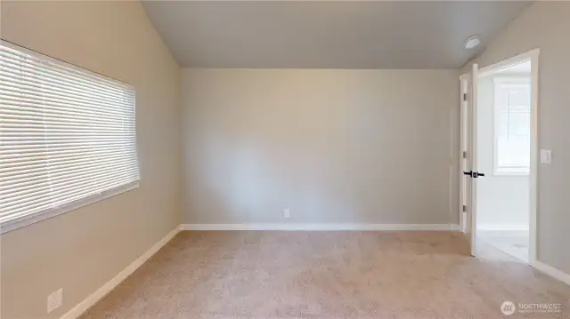 The primary suite features a deep closet with ample storage, private bathroom with barn door, vaulted ceiling and more!