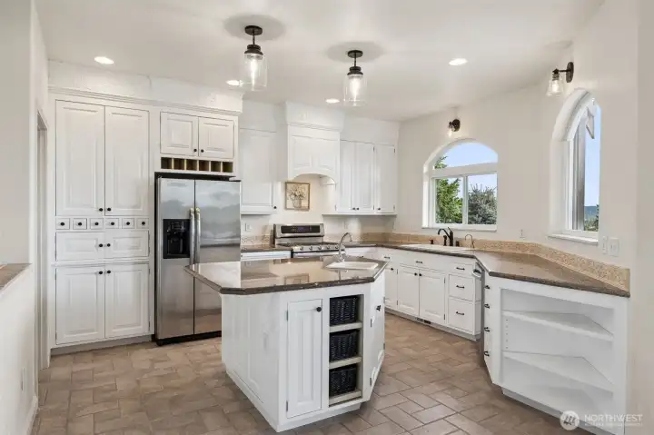 Updated granite island kitchen, new lighting, updated cabinets, hardware & faucet.