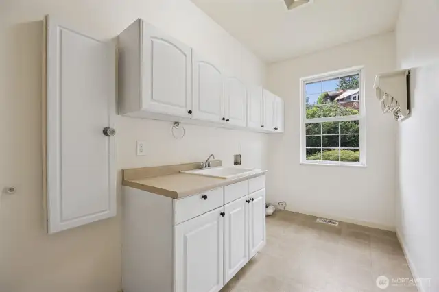 Upstairs Laundry with sink and plenty of storage