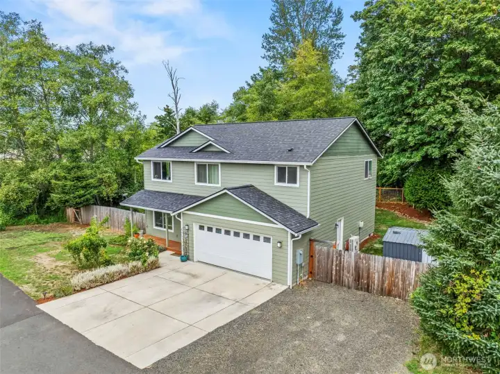 Corner lot, storage shed, fenced back yard, concrete parking apron...