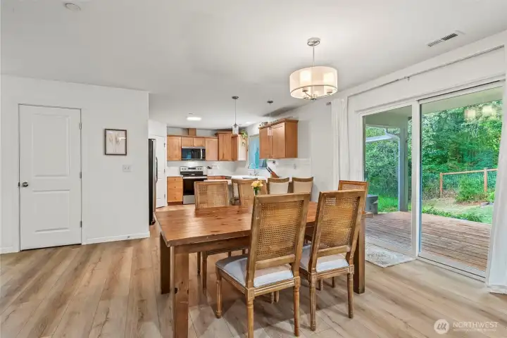 Views to covered porch and beyond from the oversized dining area...