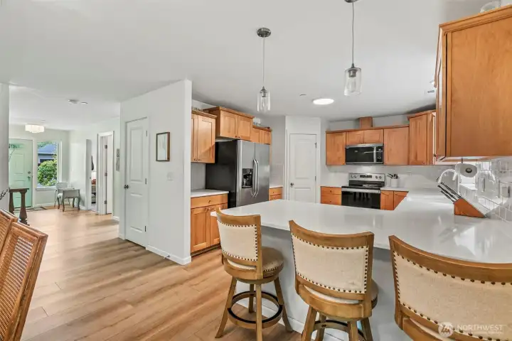 Eating peninsula with pendants flanks the U-shape kitchen...