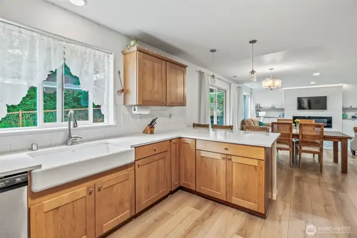 Back yard views over the beautiful farm sink; eating peninsula plus dining! Life-proof plank flooring throughout the main living areas of this lovely home!