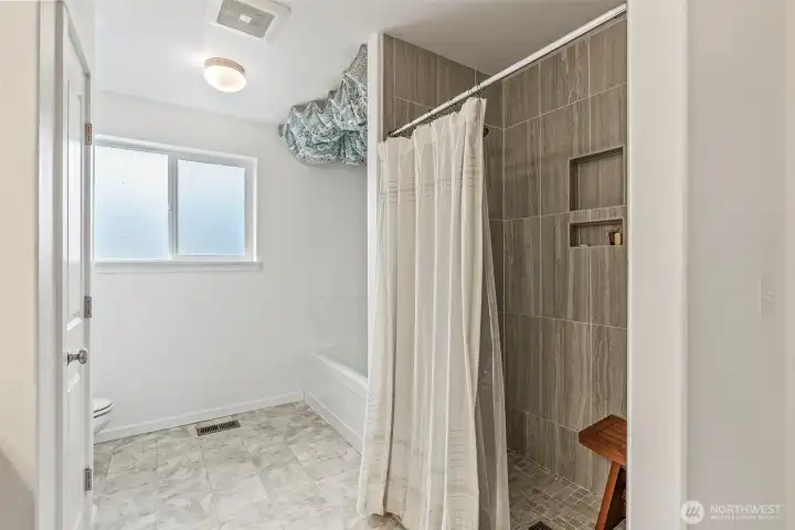 Tiled step in shower plus tub in primary bath.
