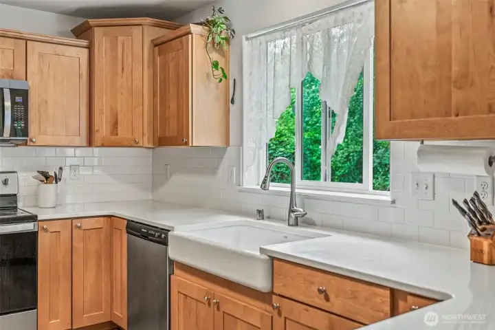 Beautiful cabinetry, stainless appliances, farm sink, tile backsplash & quartz countertops...