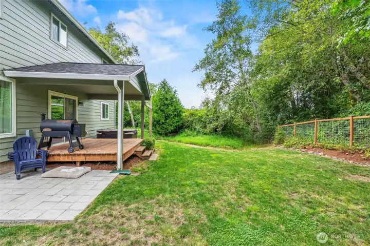 Covered cedar deck for grilling out of the weather, large fenced back yard plus pavered patio...