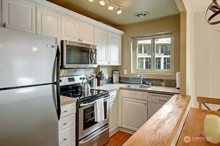 Great cabinet space, track lighting, and open to Living/Dining.