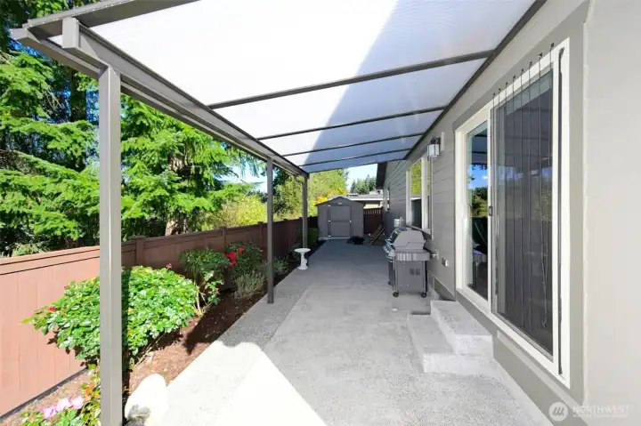 Nicely landscaped and low maintenance backyard with a partially covered large patio.  Shed stays for additional storage!