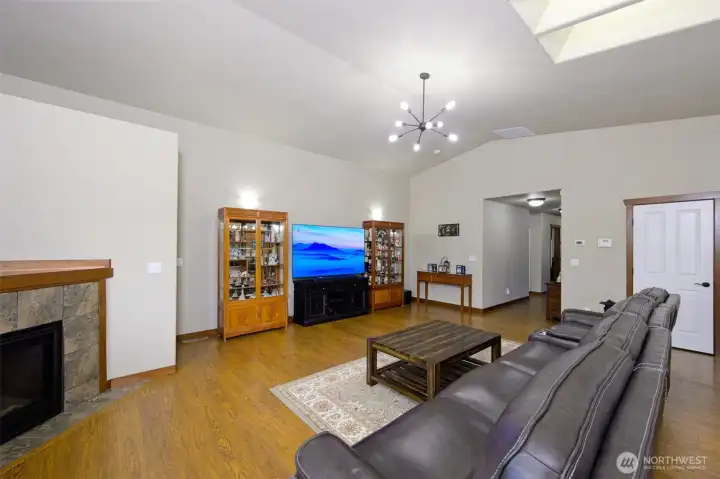 Large living room with luxury vinyl flooring and a gas fireplace.