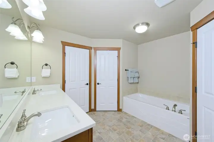 5-piece primary ensuite with Quartz countertops and cherry wood cabinets.