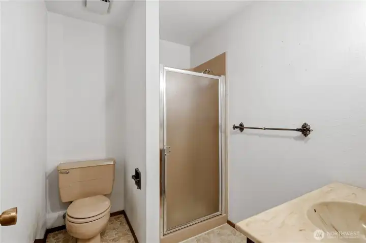 Three quarter bath between the family room and off the garage.