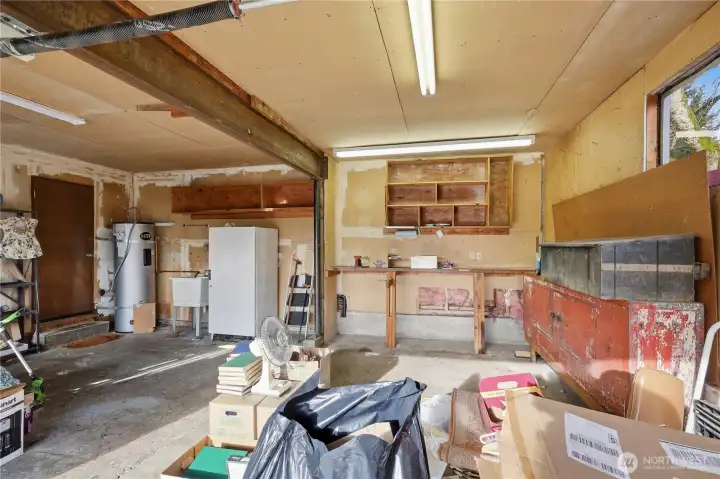 Over sized hot water heater is located in the garage. Freezer does not come with the house, but can be purchased.