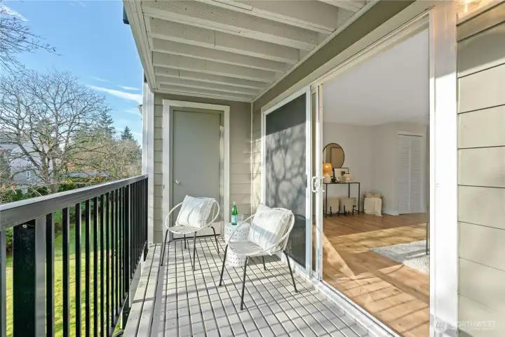 Covered balcony with newer deck and metal railings. Easy access to private storage closet.