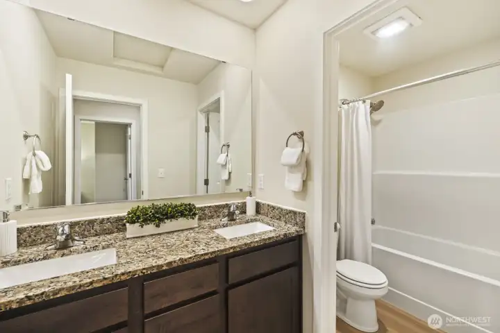 Upstairs full bathroom with double sinks and granite counters