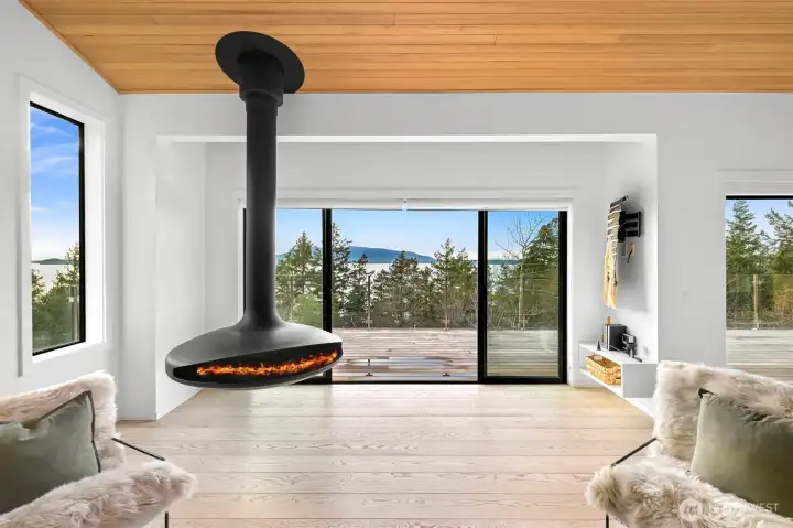 Suspended fireplace from France overlooking water in living room