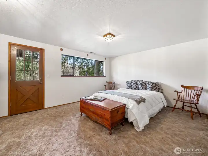This is one of three large windows running the length of this room, with a door that leads to the backyard and easy access to the back deck.