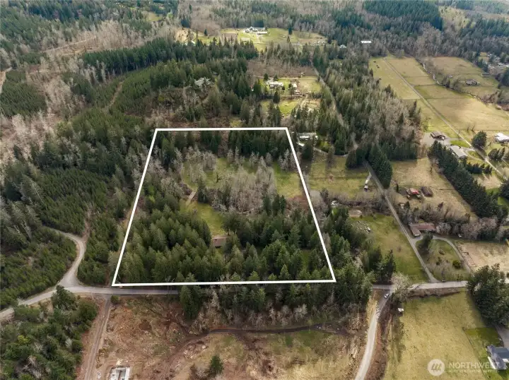 This view faces to the south (north is at the bottom of the picture). The house is at the center of the lower part of the property. See the picture with lot lines for more clarity.