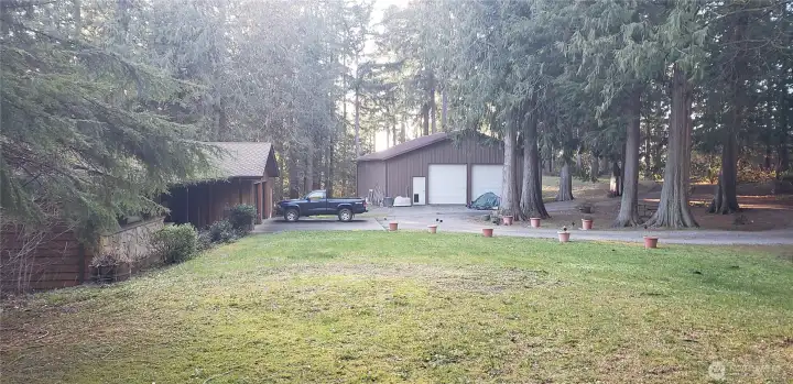 Here you can see the large semi-circular driveway, house on the left, and large detached garage/shop in the far section, with the front yard in the foreground.