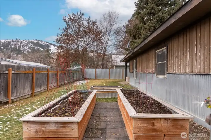 The sunny yard and raised beds are a gardener's dream. Grow your own veggies!