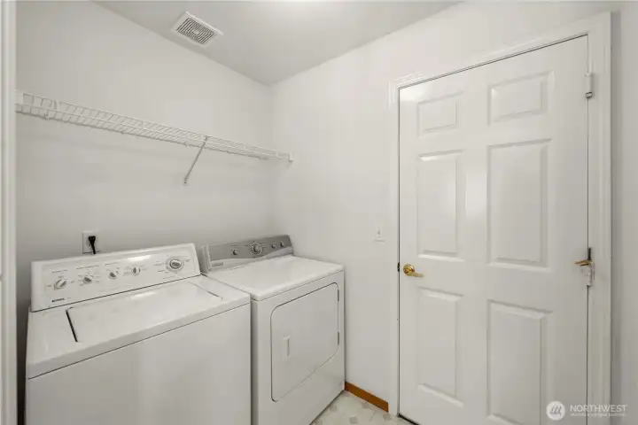 Utility room off of kitchen with door to garage