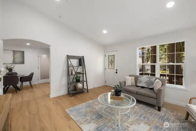 View from one corner of the living room looking towards the entry door.