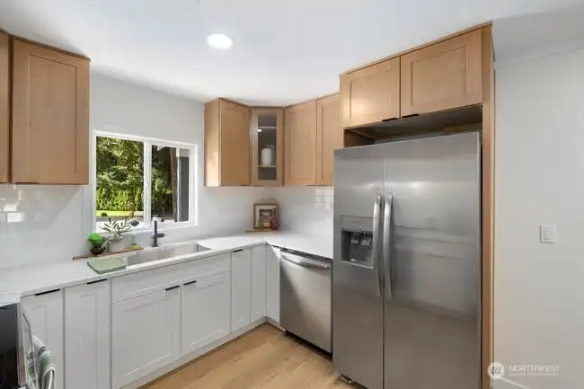 The completely redesigned kitchen with quartz counters, all new stainless steel appliances, and new cabinetry.