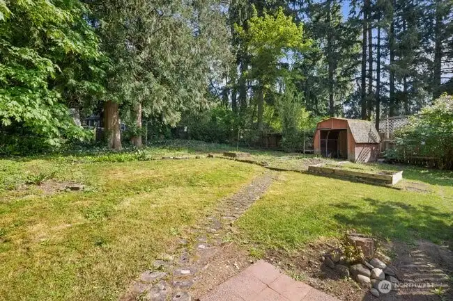 The fenced backyard offers a wonderful place to play amongst the trees and shrubs!