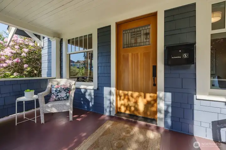 Welcoming covered front porch, newly painted, stained front door with beautiful glass work.