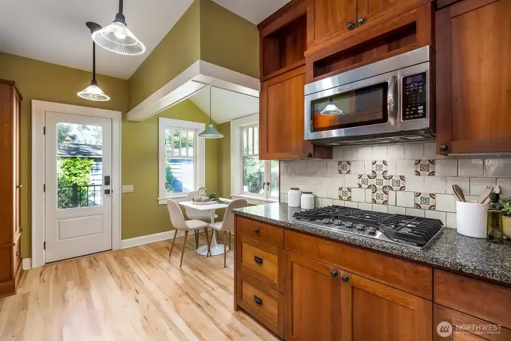 Gas cooking, beautiful tile work throughout and more space for another built-in desk or more counterspace. Enjoy a morning cup of coffee in the breakfast nook. It overlooks the amazing yard.
