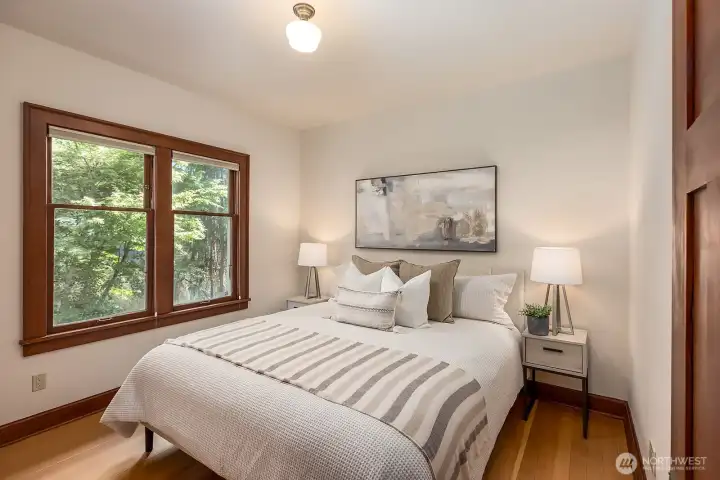 Main floor second bedroom, beautiful wood work throughout the house and natural light.