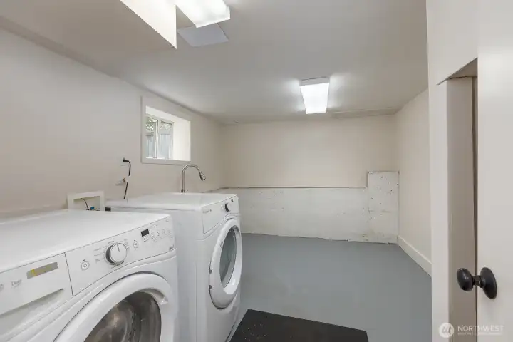 Spacious utility room with storage space for bikes or a great hobby area.