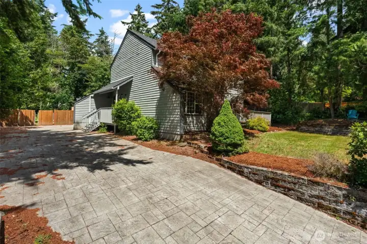 Inviting front approach framed by mature trees, colorful landscaping, and ample driveway space. Inviting front approach framed by mature trees, colorful landscaping, and ample driveway space.