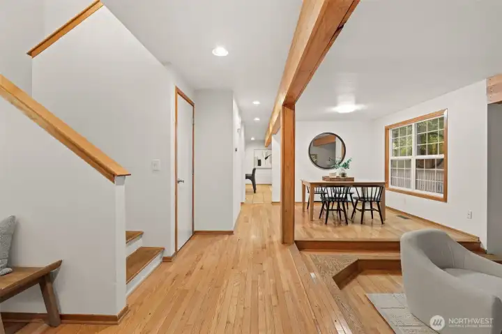 Natural wood beams and hardwood flooring add warmth and character to the connected living and dining areas. Natural wood beams and hardwood flooring add warmth and character to the connected living and dining areas.