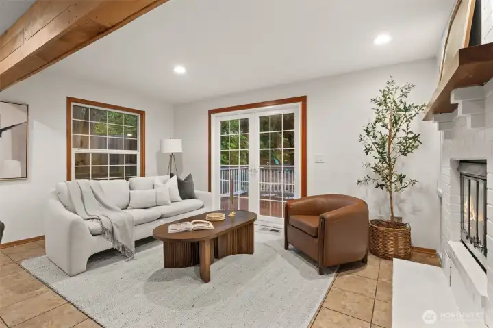 French doors connect the family room to the deck, creating an easy transition between indoor and outdoor spaces. French doors connect the family room to the deck, creating an easy transition between indoor and outdoor spaces.