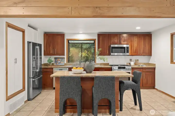 Kitchen features a large center island with seating, abundant cabinetry, and generous counter space. Kitchen features a large center island with seating, abundant cabinetry, and generous counter space.