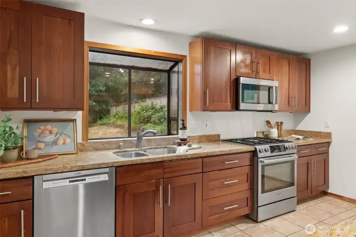 Granite countertops and island seating create a practical and versatile kitchen workspace. Granite countertops and island seating create a practical and versatile kitchen workspace.