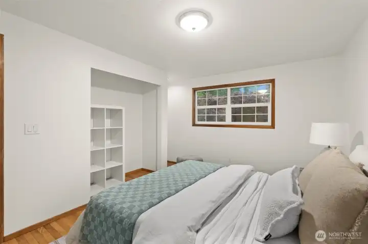 Bedroom includes hardwood flooring and a flexible alcove area suitable for storage or organization. Bedroom includes hardwood flooring and a flexible alcove area suitable for storage or organization.