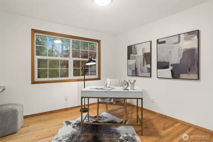 Versatile room features hardwood flooring, a large window, and space for a home office, hobby room, or guest accommodations. Versatile room features hardwood flooring, a large window, and space for a home office, hobby room, or guest accommodations.