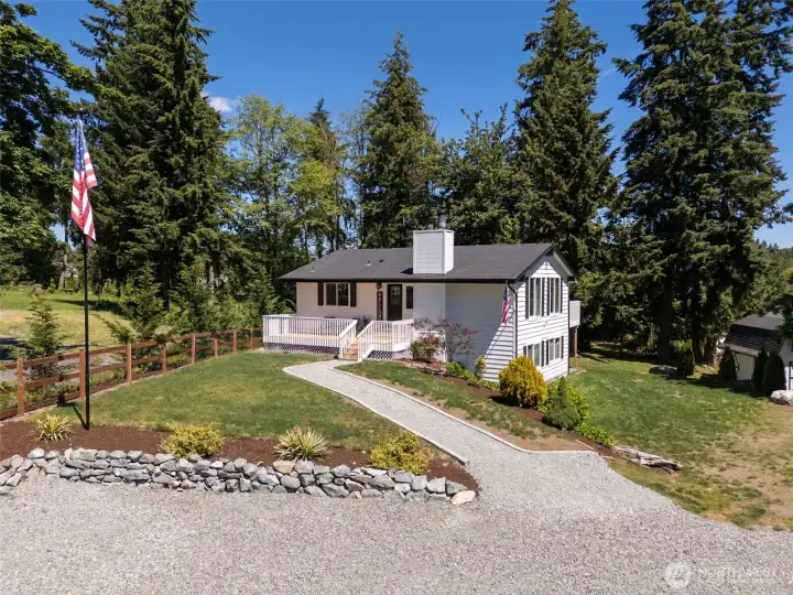 From the black & white exterior + shutters to the flagpole - this home has curb appeal