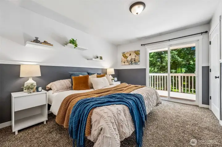 Main level primary bedroom with deck access