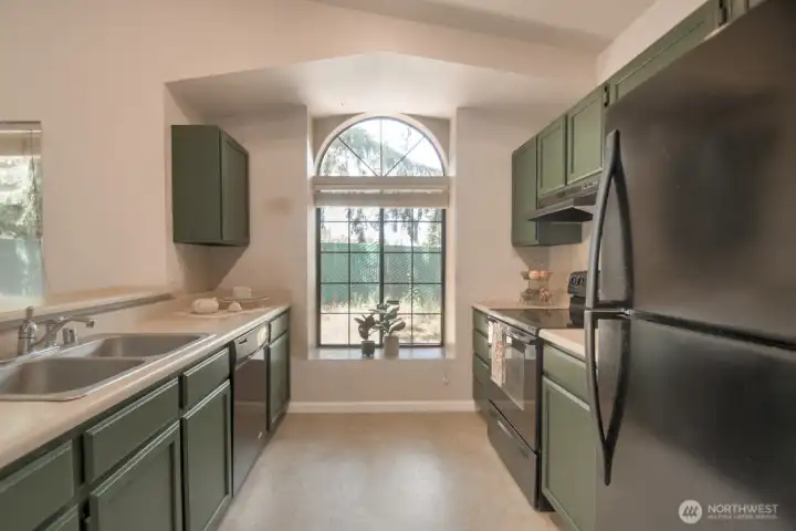 ...and features a sunny window nook as well. All black appliances.