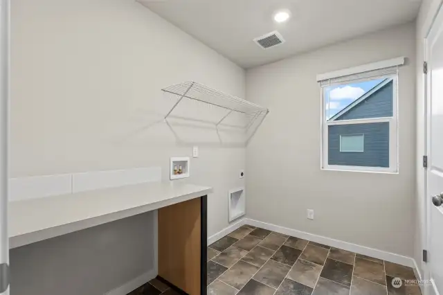 Spacious laundry room with storage - conveniently located upstairs