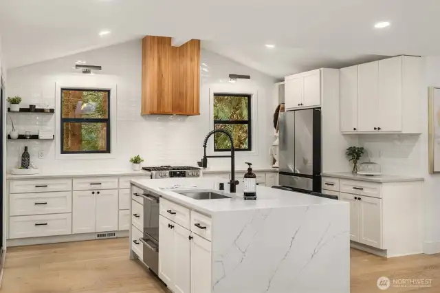 Updated, bright kitchen with oversized island for entertaining or eating.