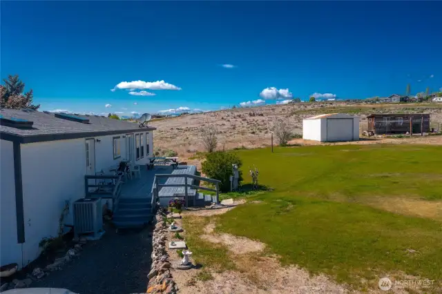 Back deck with storage building and chicken house