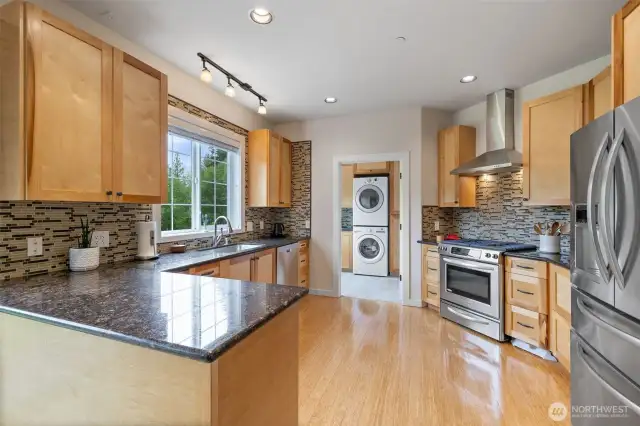 Kitchen with granite countertops, stainless steel appliances.